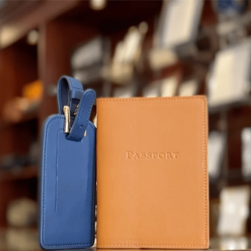 Blue leather luggage tag and tan leather passport cover